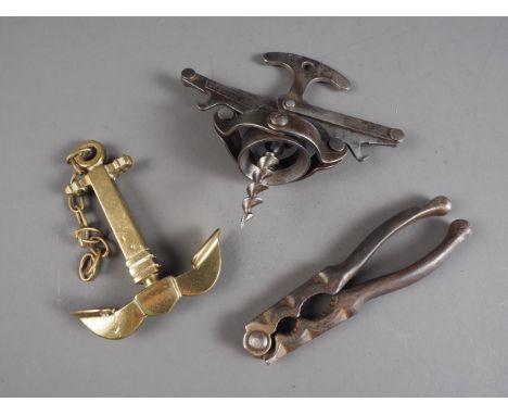 A 19th century French "Debouchet" corkscrew, a nutcracker and a novelty anchor corkscrew, and three Italian turned wood bowls