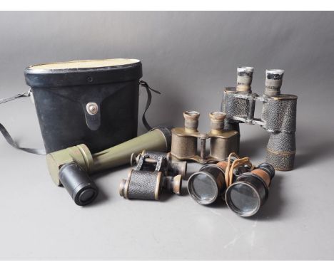 A pair of military World War II brass and leather cased binoculars, a similar pair of German binoculars, a pair of American b
