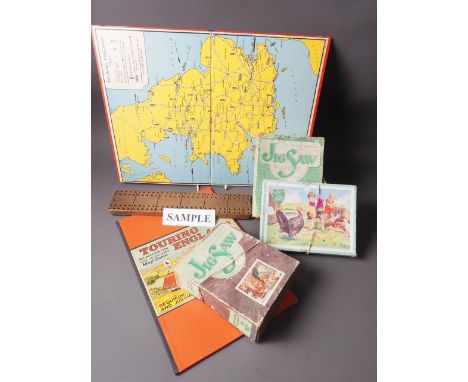 Twelve early 20th century wooden jigsaws, "Touring England", early 20th century board game, two other games and a cribbage bo