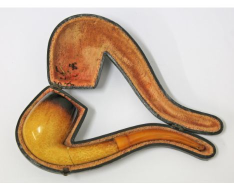 A meerschaum vintage pipe with butterscotch amber mouth piece.