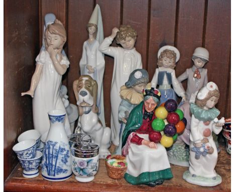 A group of 10 Nao figures, a Royal Doulton figure, two Royal Worcester egg coddlers and a Japanese liquor set.