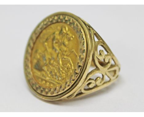 A 9ct gold ring set with a half sovereign, gross wt. 7.4g.