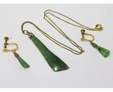 A jade pendant on rolled gold chain and a pair of jade earrings.