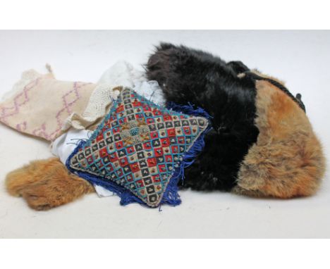 An Edwardian pin cushion together with various furs and linen.