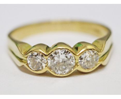 An 18ct gold three stone diamond ring, gross wt. 3.8g, size M.