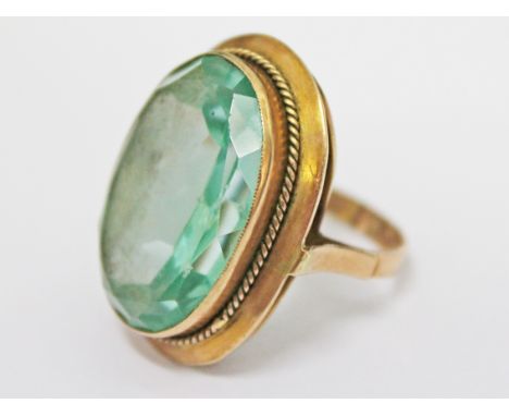 A ring marked '585' set with a pale green stone, gross wt. 15.3g, size Q.