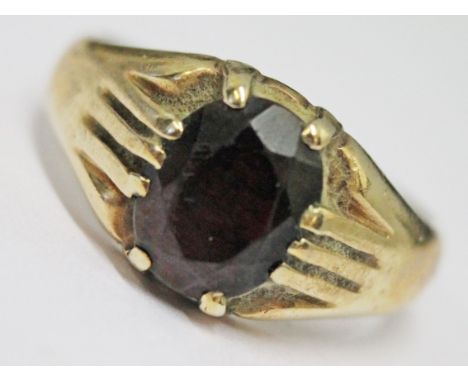 A 9ct gold ring set with a deep red stone, gross wt. 6.6g, size T.