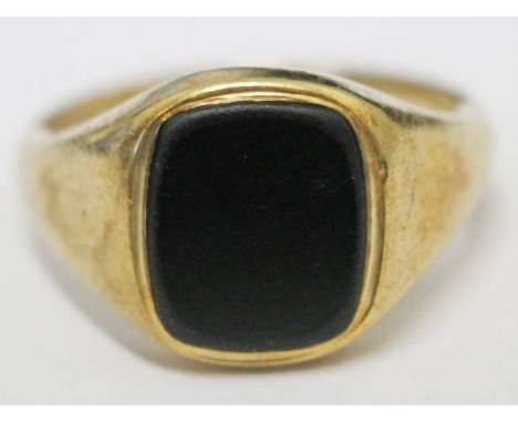 A 9ct gold signet ring set with black stone, gross wt. 8g, size U.