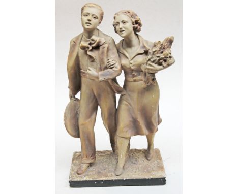 A French Art Deco plaster figure formed as a young couple, signed, height 48cm. Condition - minor losses to finish, free from