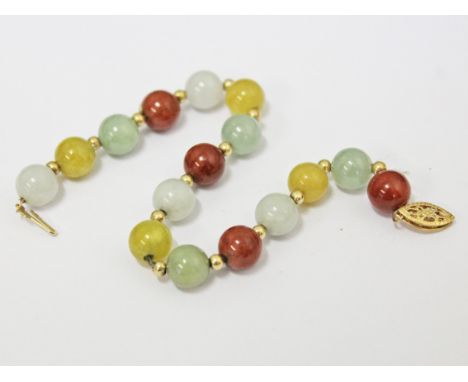 A 14ct gold multi-colour jade bracelet, length 17.5cm, gross wt. 15.3g.