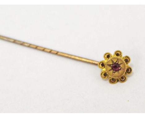 A 9ct gold hat pin set with a ruby, gross wt. 0.8g.