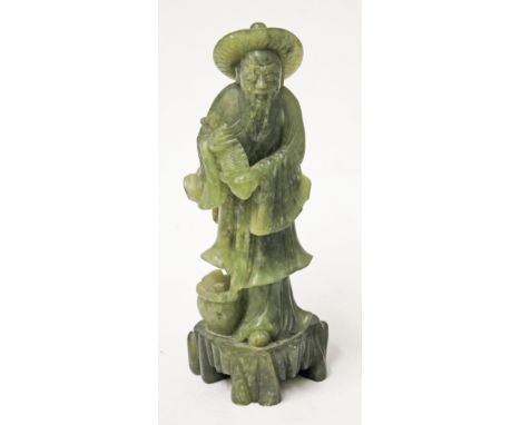 A Chinese carved jade figure of a fisherman with his catch, height 24cm. Condition - good, minor nibbles only, no cracks nor 