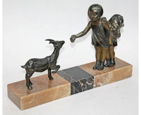 A 1930s French Art Deco formed as two bronzed spelter girls feeding a small deer on marble and onyx base signed 'R Scaly', le