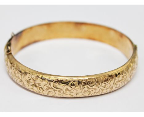 A 9ct gold bangle, wt. 12.4g.