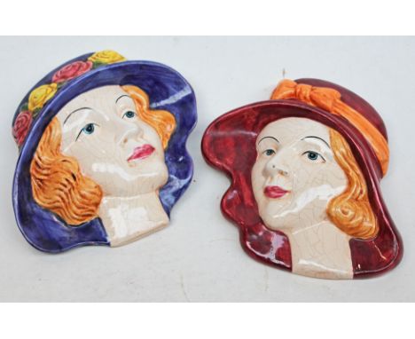Two Art Deco pottery wall masks, length 16cm each. Condition - slight chip to glaze on one (pictured right) no further damage