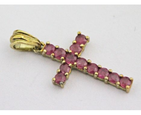 A 9ct gold ruby crucifix, wt. 0.9g.