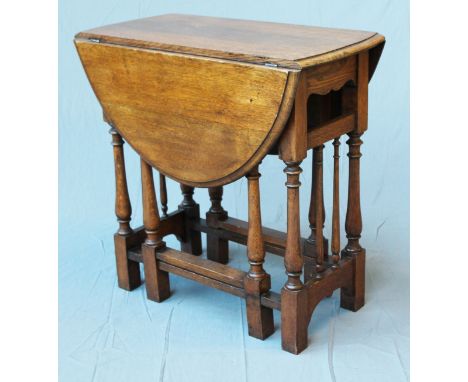 A reproduction oak gate leg table with turned legs and spindle sides. Min. L76cm D39cm H73cm.