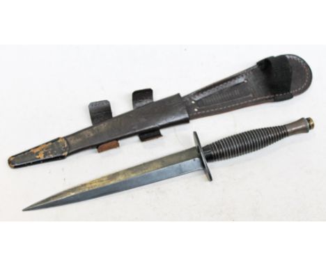 An FS third pattern fighting knife, the guard inscribed 'Sheffield England', with leather scabbard, length 29.5cm. Condition 