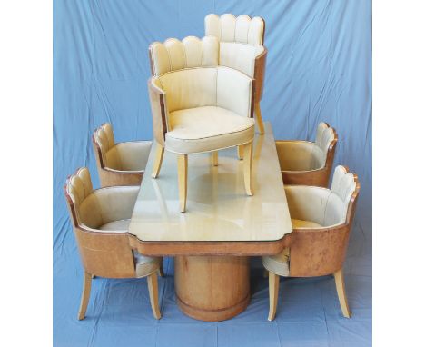 An Art Deco bird's eye maple dining table and six chairs attributed to Harry & Lou Epstein, the table having shaped edge on t