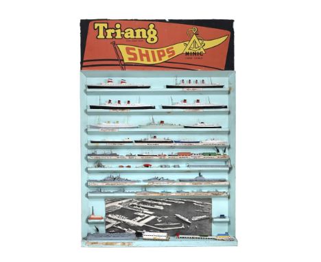 A RARE TRI-ANG MINIC SHIPS SHOP DISPLAY STAND With approximately twenty four water-line models in 1.1200 scale, harbour piers