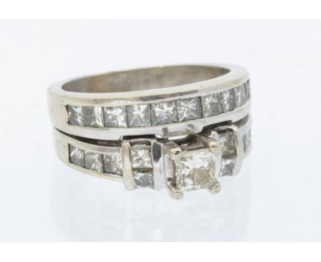 A diamond set white gold double ring, comprising an engagement ring set with a princess cut diamond to the centre approx 0.39