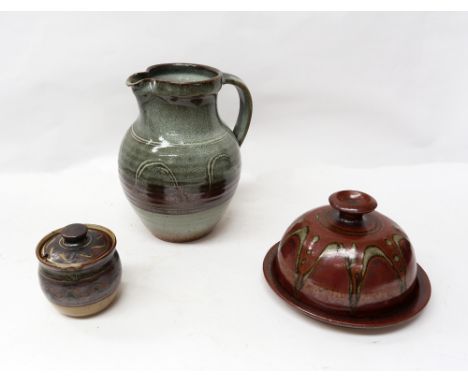 Sidney Tustin of Winchcombe Pottery; a preserve jar and cover, marked and initialled ST; a Winchcombe pottery water jug with 