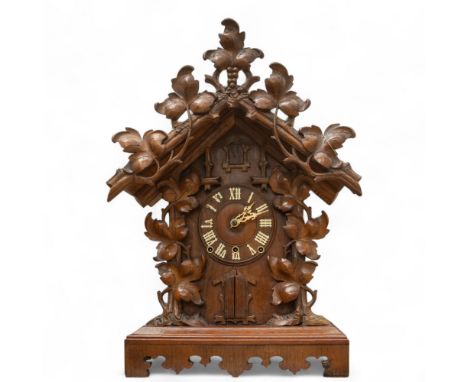Gordian Hettich, Sohn (GHC) A very large Black Forest carved beech 'Trumpeter' mantel clock, circa 1890, having bone Roman nu
