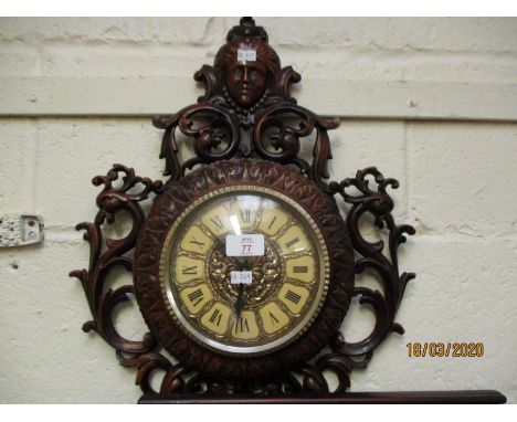 PLASTIC FRAMED OPEN WORK WALL CLOCK WITH FIGURE MOUNTED TOP