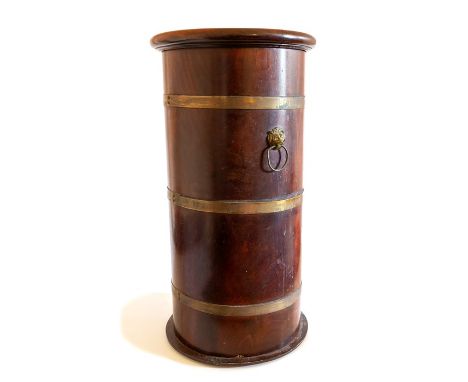 A 19th Century mahogany cylindrical shaped stick stand, having brass bound sides, lion mask handles, 57cm high