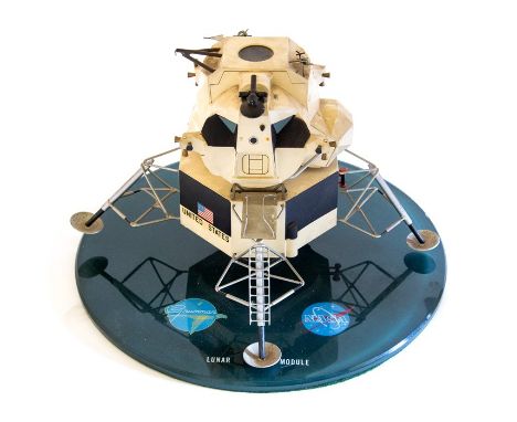 A model of Grummar Lunar Module on stand, the 26cm diameter base has colour logos of both Grumman’s and NASA with the text ‘L