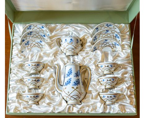 A Romanian porcelain eight piece coffee set, white with raised gilt and blue floral decoration, comprising coffee pot, sugar 
