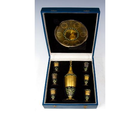 A Russian silver-gilt and black enamel vodka set, comprising decanter with stopper, six tots and a circular tray with fitted 