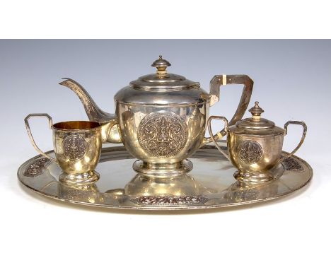 An early 20th Century&nbsp;Thai silver tea set, comprising&nbsp;teapot, a sugar basin and cover, a milk jug and oval tray wit