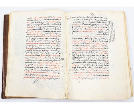 Islamic manuscript. Arabic, key phrases in red, remainder in black ink. Waxy laid/chain-lined paper, bound in embossed leathe