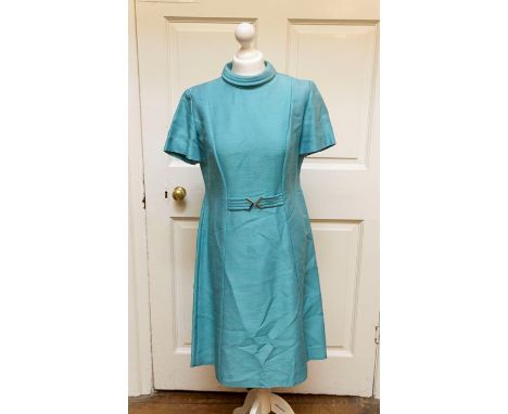 Ladies light blue dress with high collar false belt with metal detail and matching long jacket.&nbsp;Harold &amp; Mary Wilson