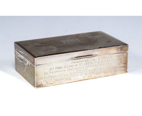 An Elizabeth II silver presentation rectangular cigarette box, engine turned cover with vacant cartouche, the front with insc