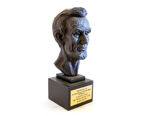 A bust depicting Abraham Lincoln by Leo Cherne (1912-1999) cast in dark patinated plaster and mounted on a black wood plinth 