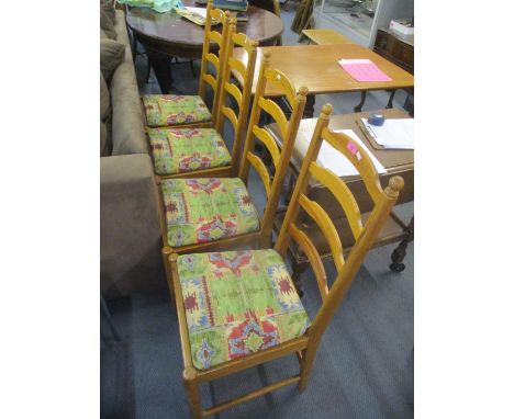 A set of four Ercol pine ladder back dining chairs 