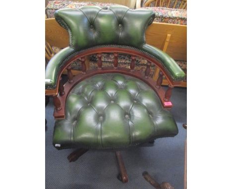 A reproduction green leather button back Captains armchair 
