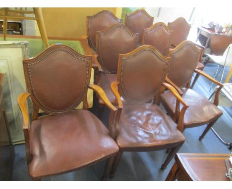 A set of eight walnut shield back corner dining chairs having button leather back upholstery 