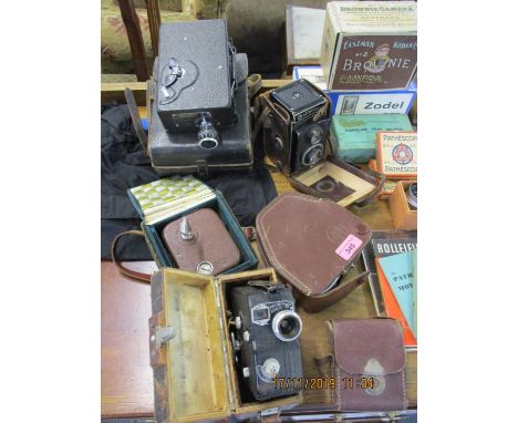 Vintage cameras and accessories to include Rolleicord, a cine Kodak, a box Brownie in original box and a Pathescope H in leat