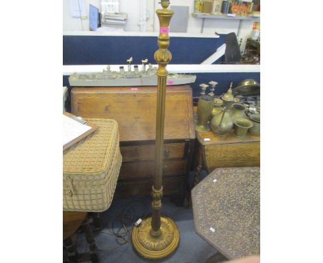A gilt painted standard lamp having a fluted column and leaf shaped base 