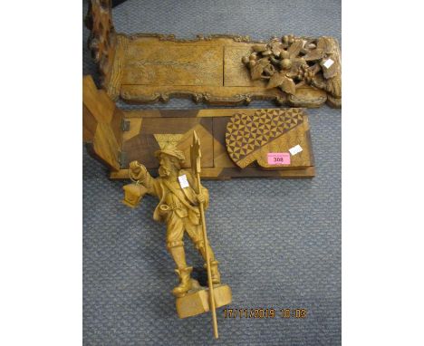 A Victorian carved walnut bookend, an Art Deco treen bookend and a carved treen figure of a man 