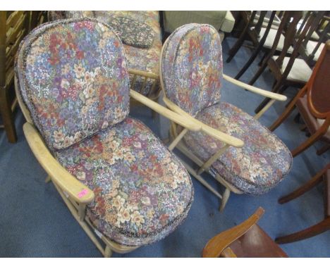 A pair of vintage blonde Ercol stick back armchairs 