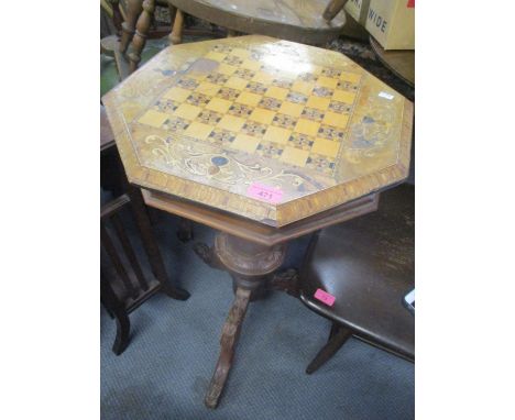 A Victorian walnut sewing/games table having an octagonal hinged top and a tripod base 