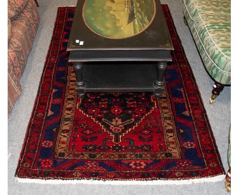 Hamadan Rug, the charcoal field centred by a serrated medallion framed by stepped spandrels and serrate vine leaf borders, 21