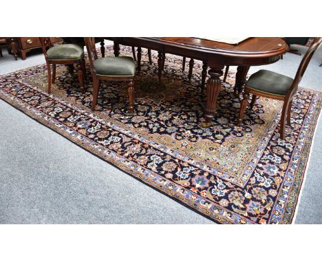 Mashad Carpet, the deep-indigo field centred by a flowerhead medallion, framed by spandrels and indigo borders of palmettes a