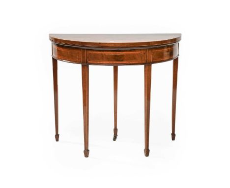 A George III Inlaid Mahogany Demi-Lune Foldover Card Table, raised on tapering square section legs and terminating in spade f
