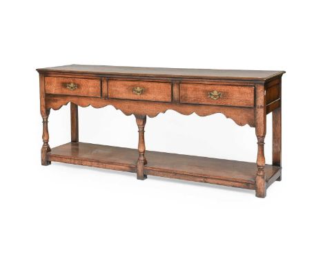 A Titchmarsh and Goodwin Style Three Drawer Oak Dresser Base with pot board stretcher, 183cm by 46cm by 76cmStructurally soun