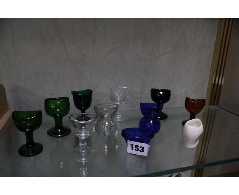 A collection of assorted glass eye baths and one ceramic bath -11